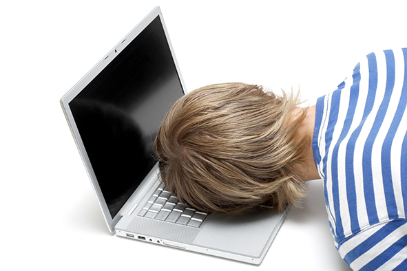 Man sleeping on a laptop keyboard.