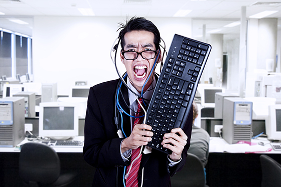 Crazy businessman hold keyboard and cables at office