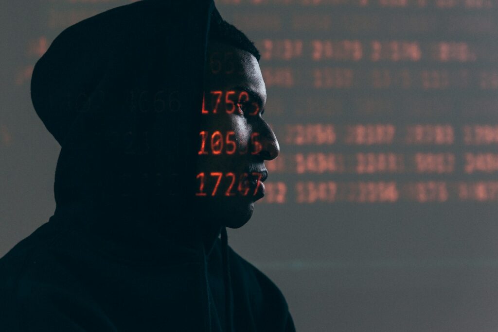 Man looking away with red, computer numbers on his face