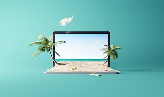 Laptop screen with an image of a beach. Sand is coming through the screen.